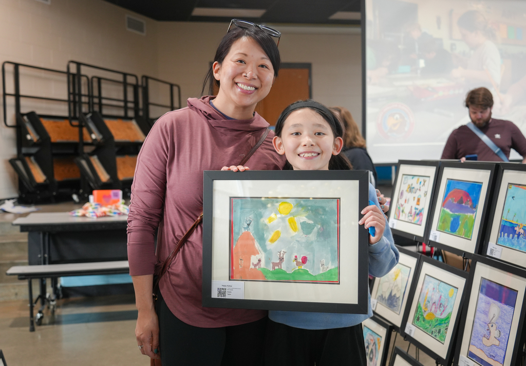 Families participating in activities and viewing student art at the Happy Hollow Art Show.