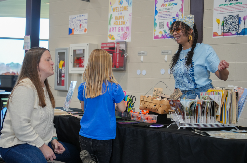 Families participating in activities and viewing student art at the Happy Hollow Art Show.