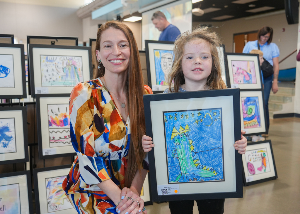 Families participating in activities and viewing student art at the Happy Hollow Art Show.