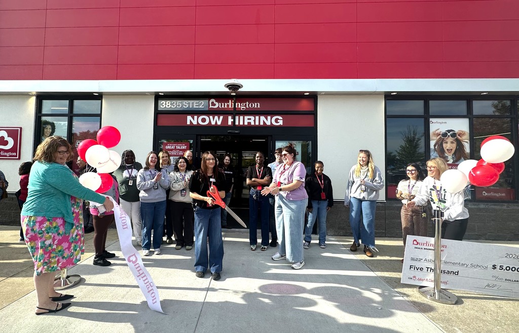 People gather at a store entrance with "Now Hiring" sign. Some hold balloons.