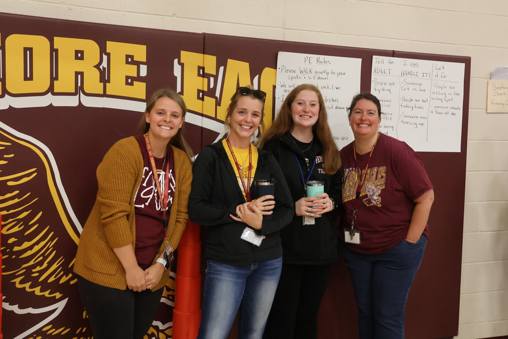 2nd grade team of teachers for pose for a picture in the gym