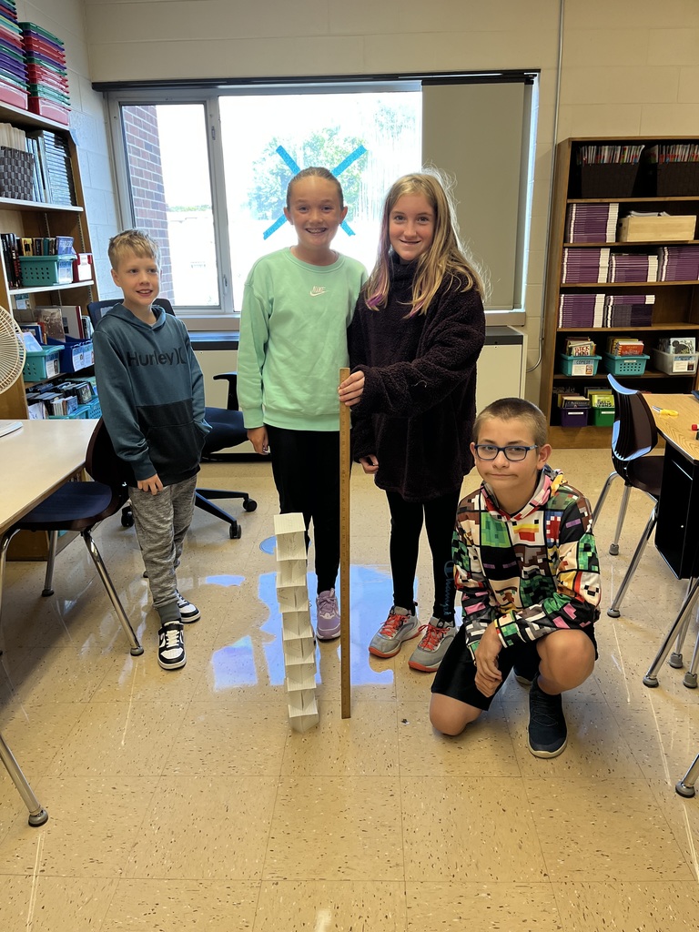 students work together to build a tower out of index cards