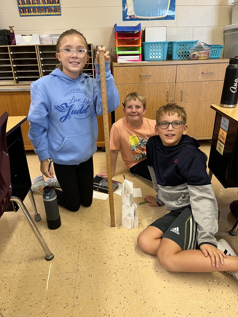 students work together to build a tower out of index cards