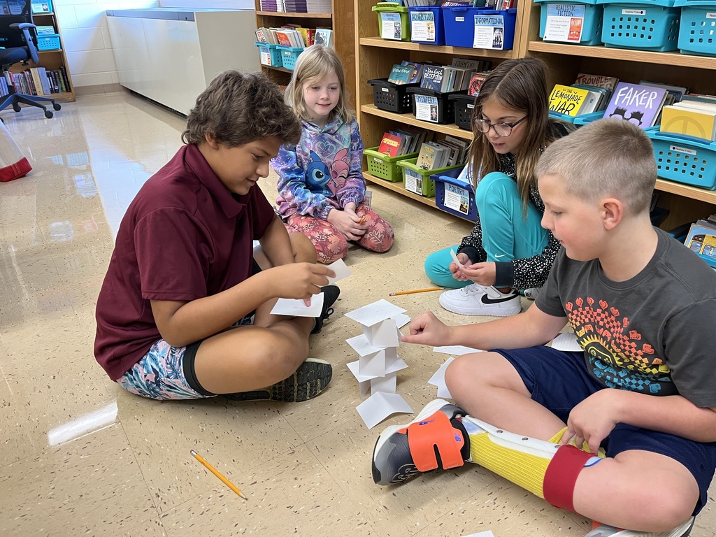 students work together to build a tower out of index cards