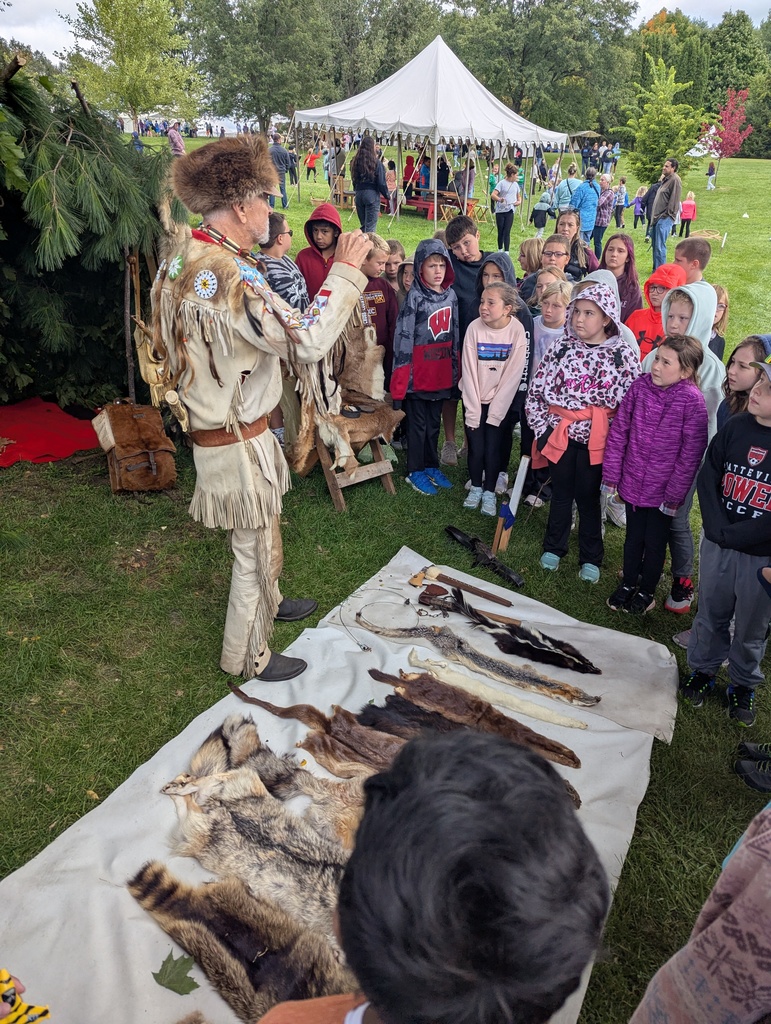 students watch as someone explains the differents furs at the platteville encampment field trip