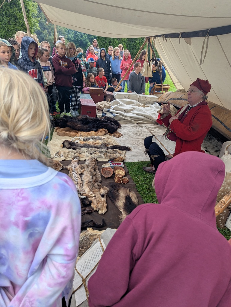 students watch as someone explains the differents furs at the platteville encampment field trip