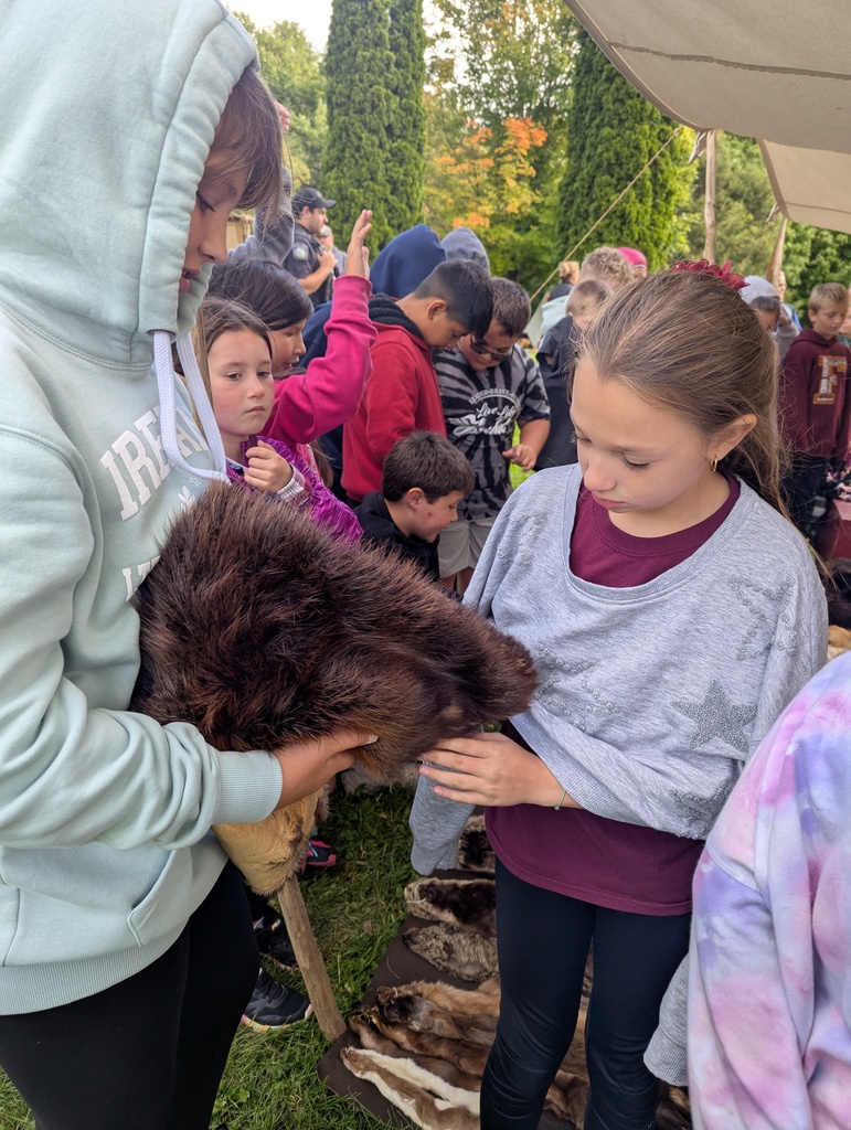 students feel a fur at the platteville encampment field trip