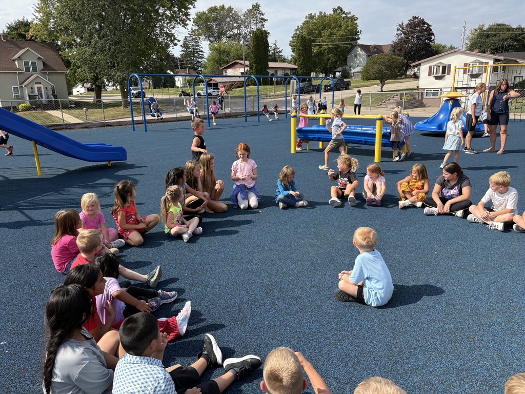 K-3 students play duck duck goose on playground