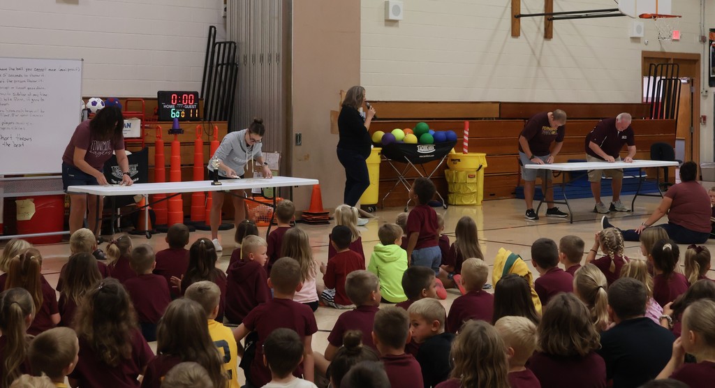 teachers compete in a puzzle teacher challenge at the PBIS assembly on Friday