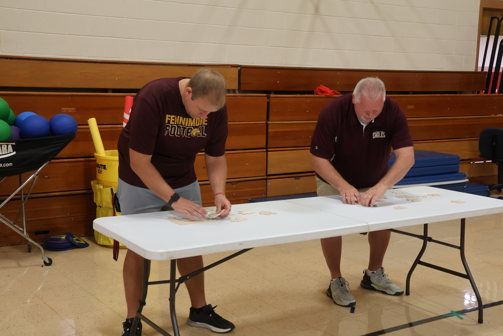 2 teachers compete in a teacher challenge at PBIS Assembly