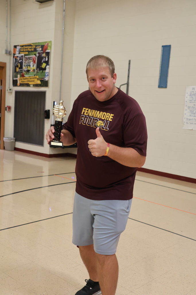 Mr. Jahnke shows off his trophy for winning the teacher challenge