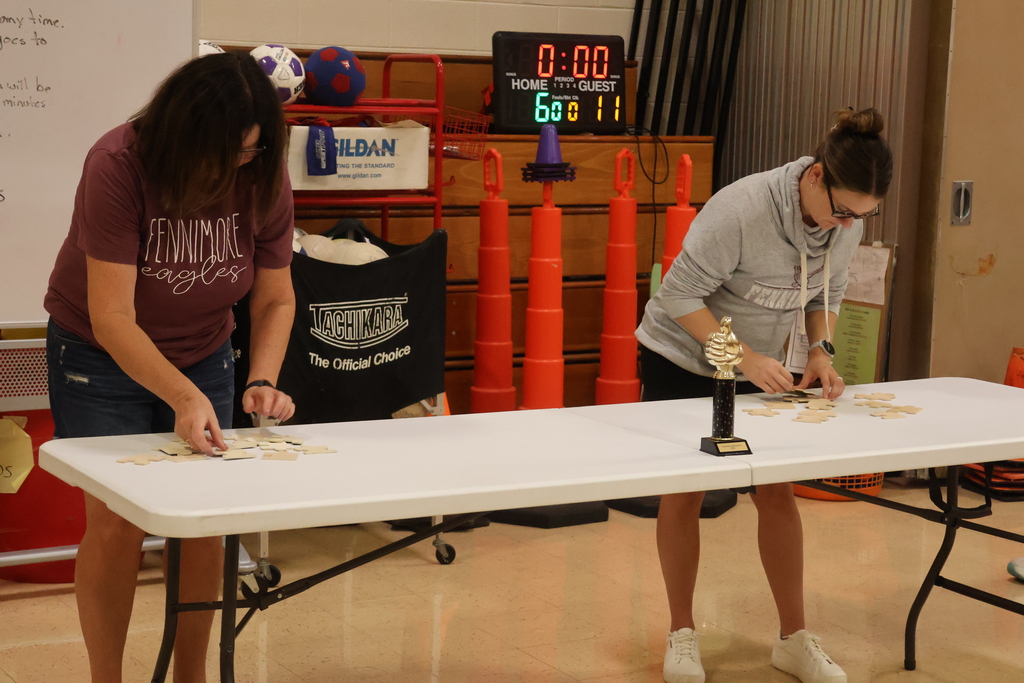 2 teachers compete in a teacher challenge at PBIS Assembly