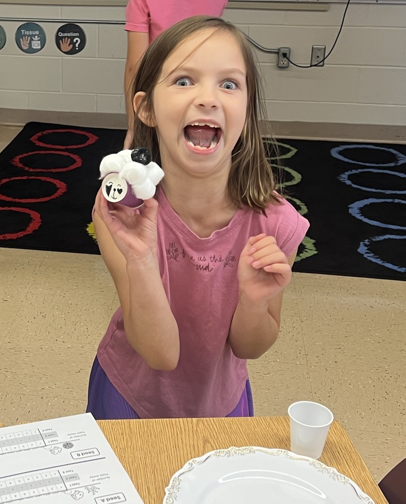 a student shows off their created "flufadoo" animal