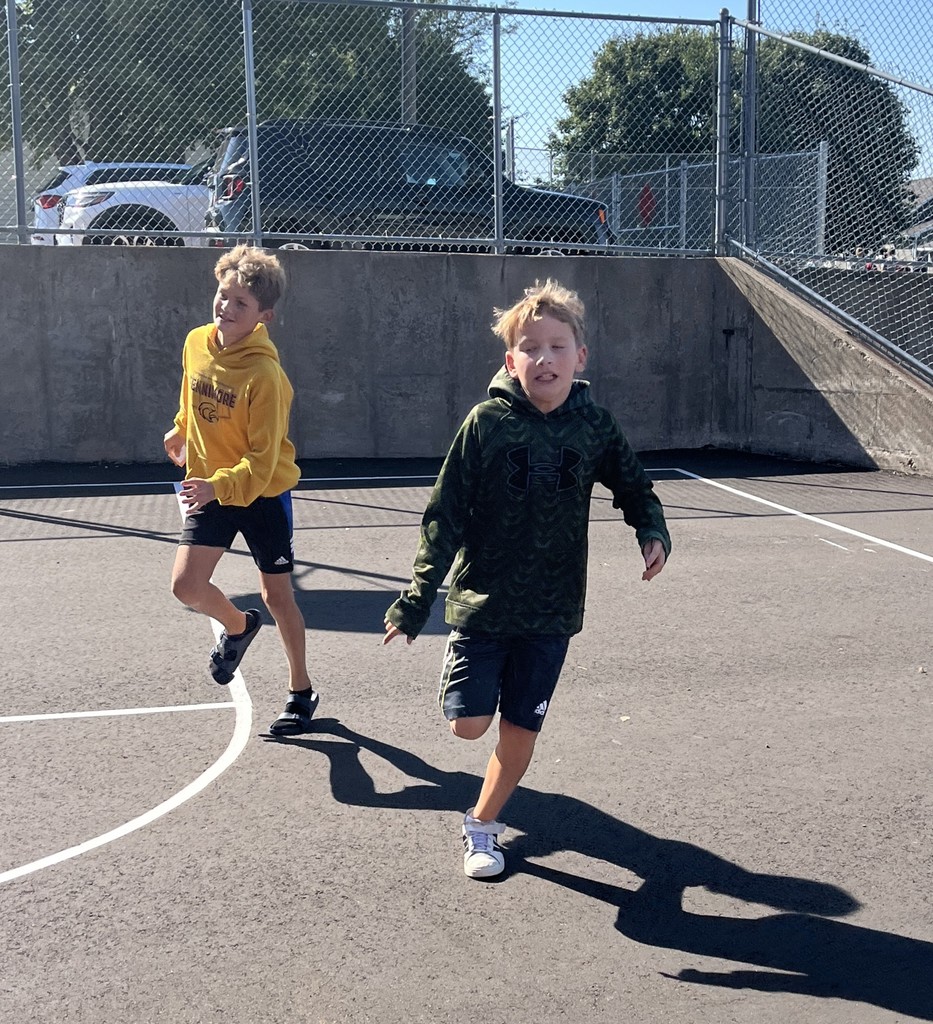 students run on playground during the predator/prey game