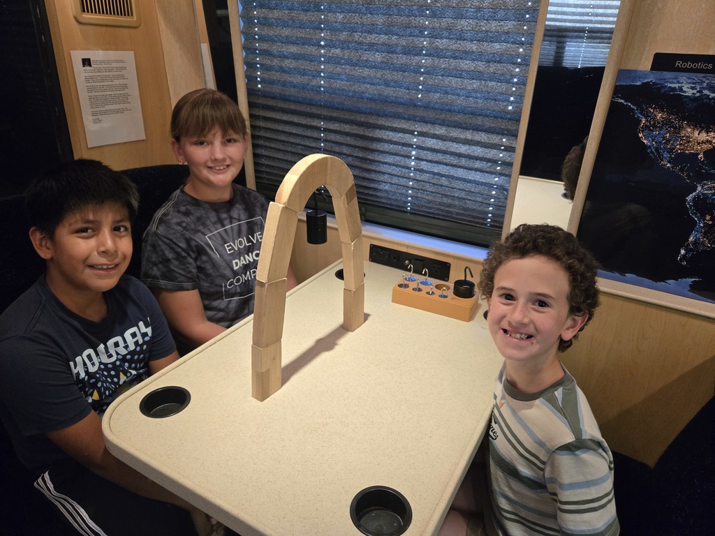 students build an arch on the STEM shuttle bus