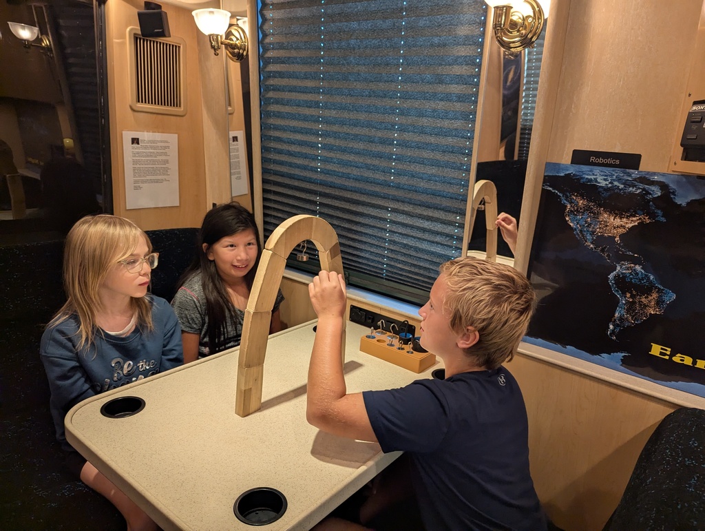 students build an arch on the STEM shuttle bus