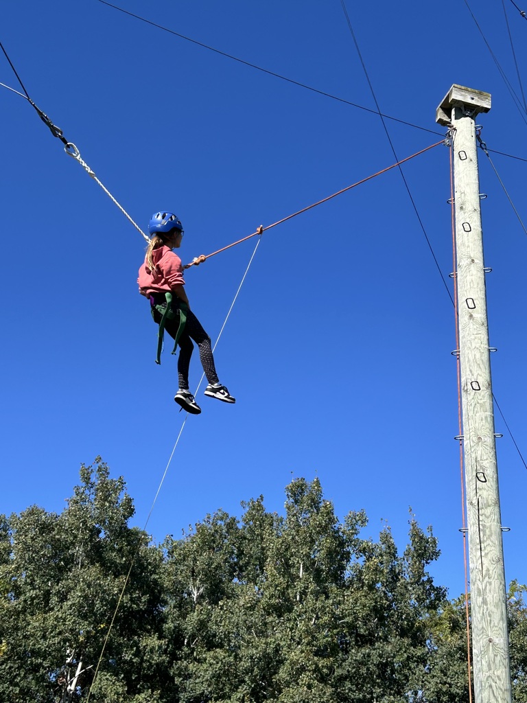a  student does the zip line at bethel horizons 