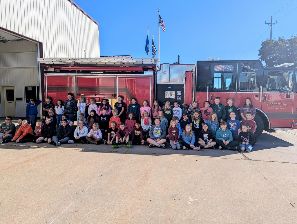 the fourth grade class poses for a picture in front of a fire truck at fennimore fire station.