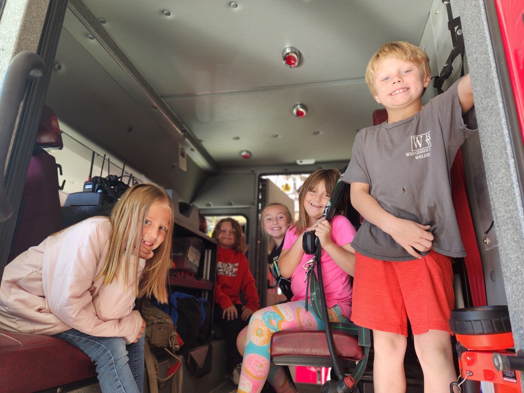students look at the inside of the fire truck at the Fennimore fire station