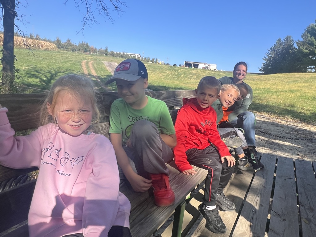 students ride the wagon at the orchard