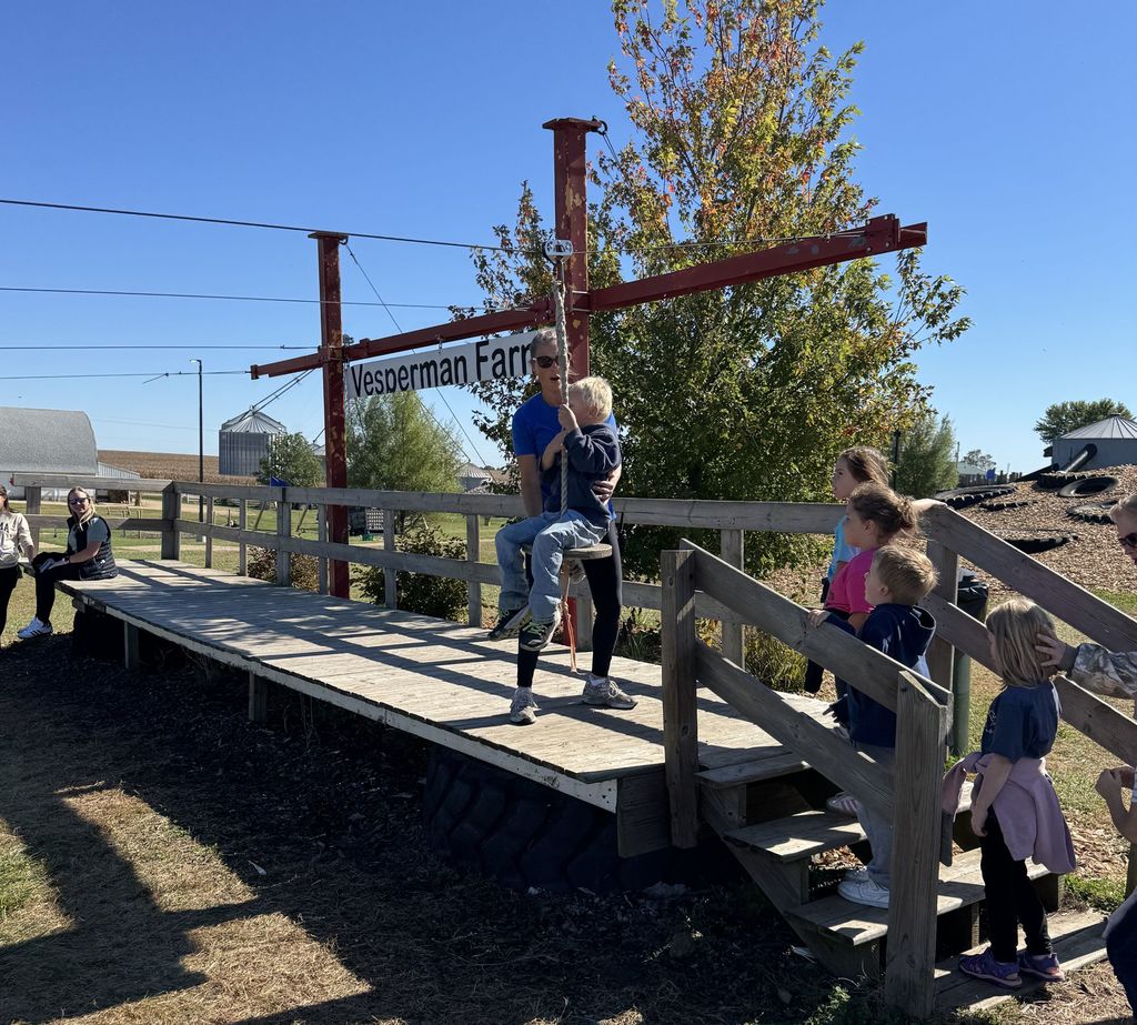 students ride on a swing at Vesperman farms