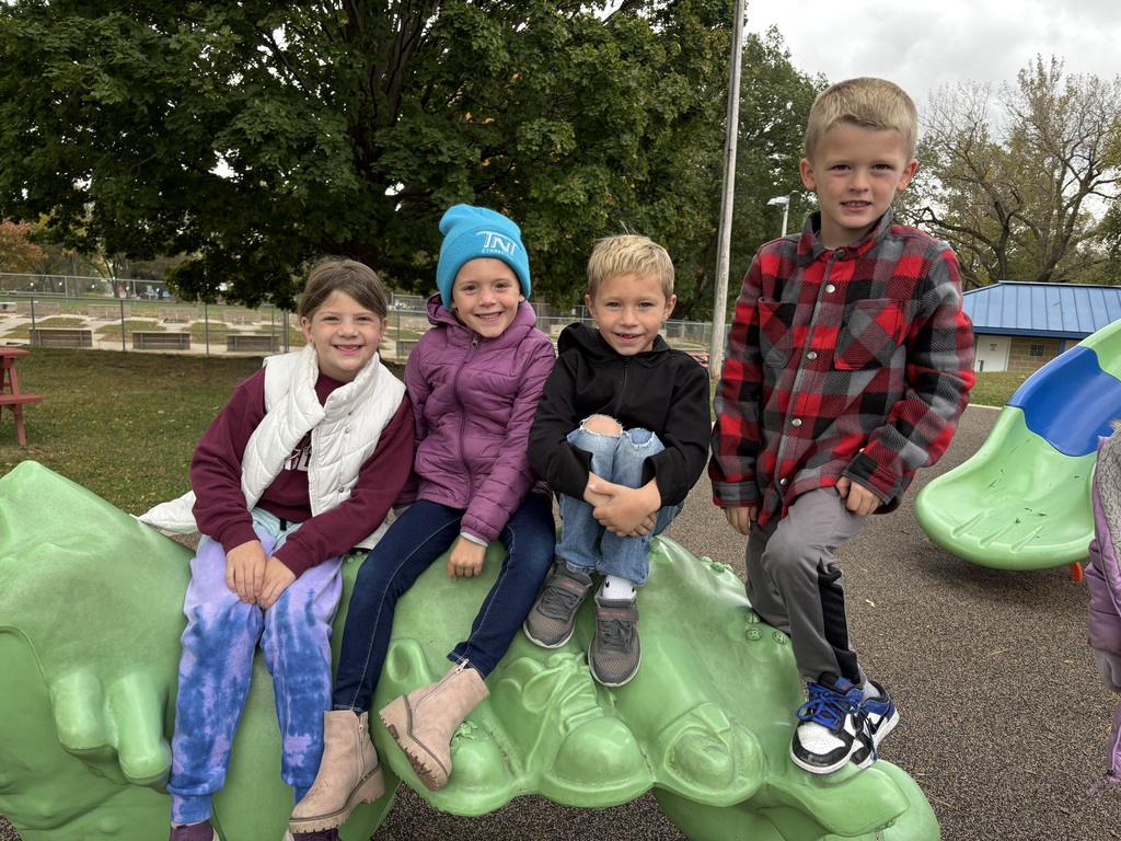 students play on equipment at a park