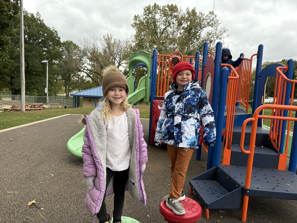 students play on equipment at a park