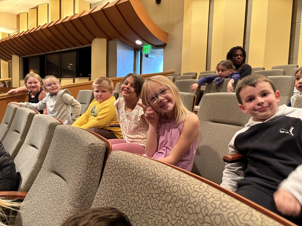 students sit in their seats at the Heritage Center waiting for the play to start