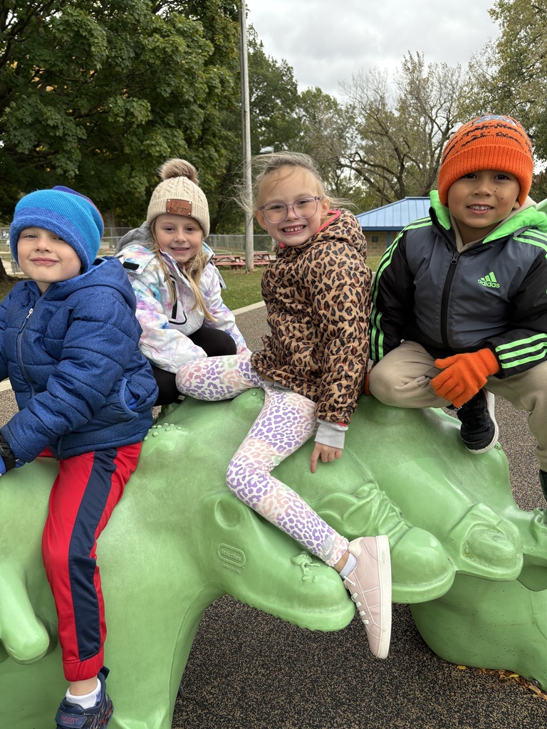 students play on equipment at a park