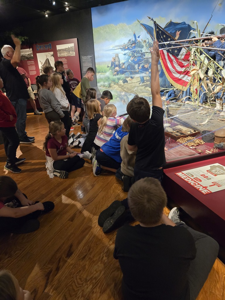 students listen to a speaker at the veterans museum in madison