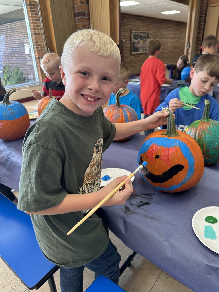 students paint pumpkins
