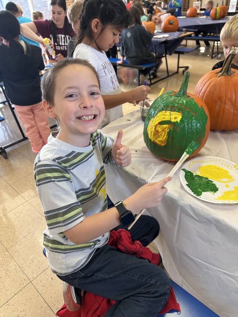 students paint pumpkins