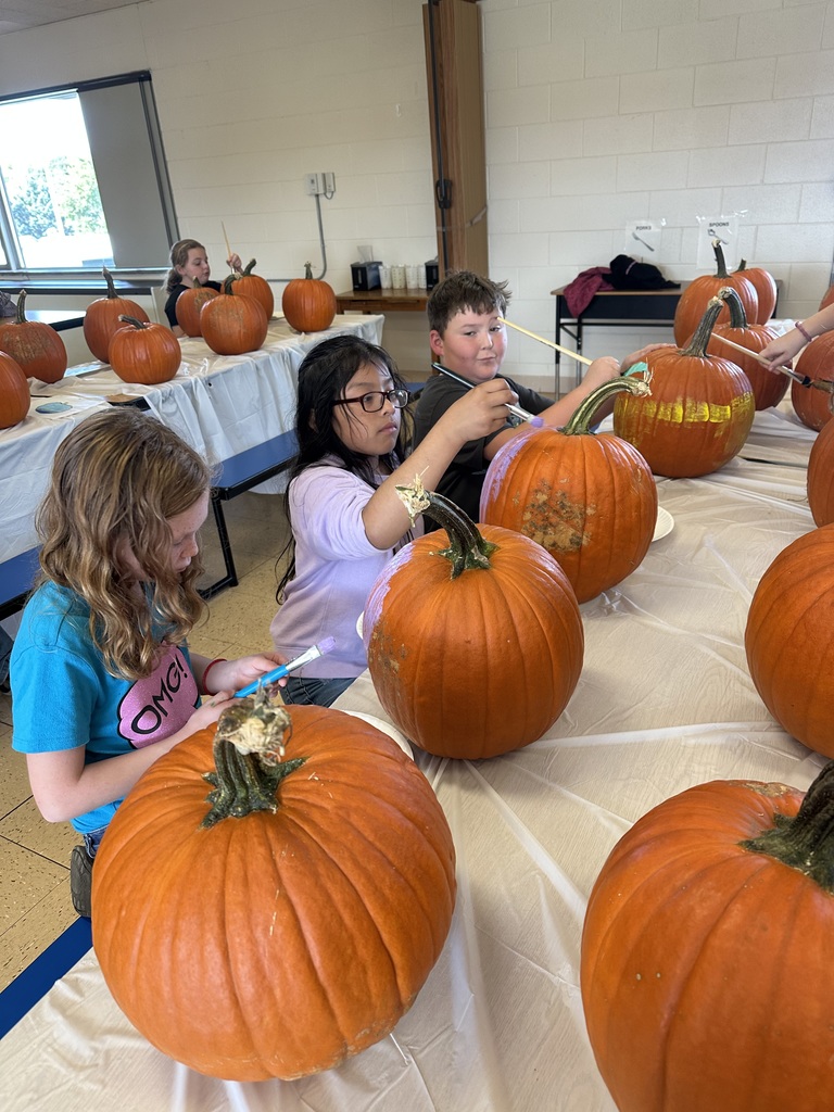 students paint pumpkins