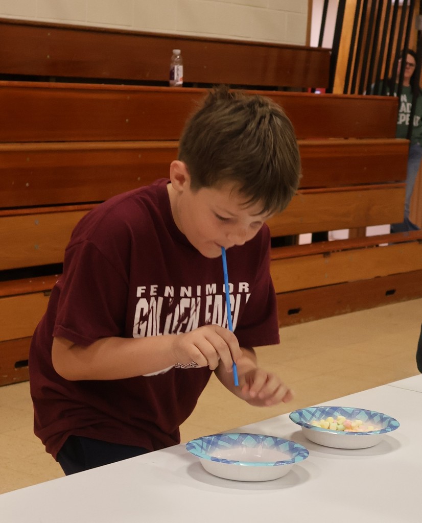 a student competes in the straw marshmallow student challenge
