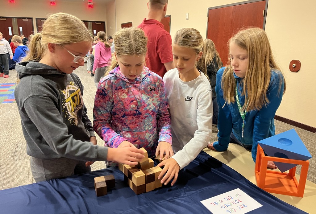 5th graders do math activities at UWP with wooden blocks
