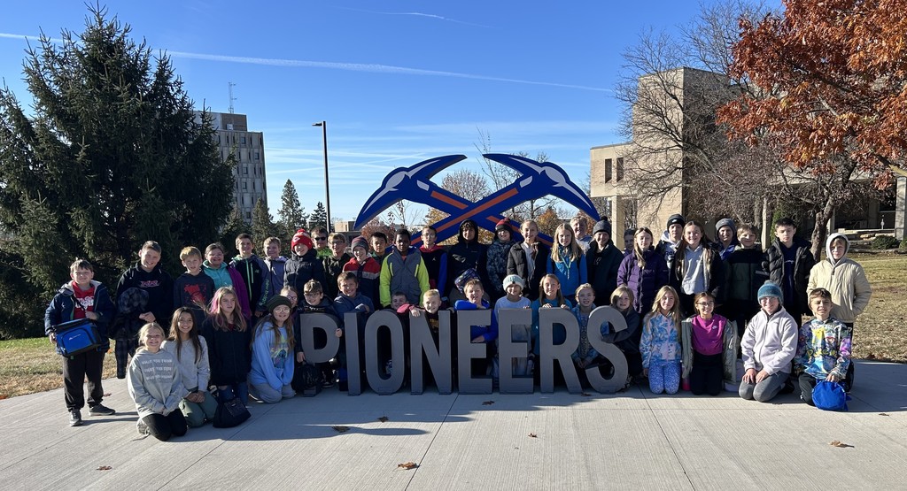 5th graders pose for a pic by the pioneers sign 
