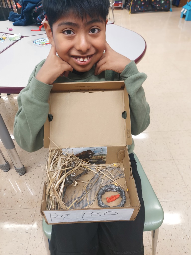 students show off their diorama