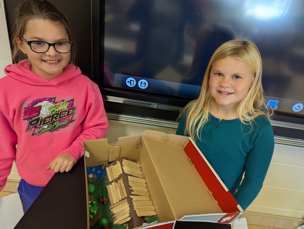 students show off their diorama
