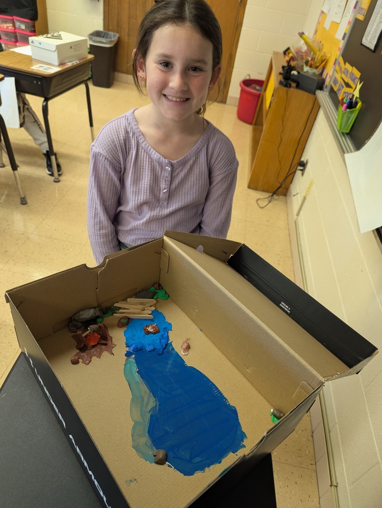 students show off their diorama