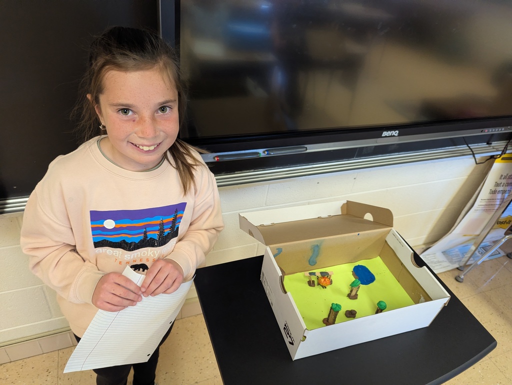 students show off their diorama