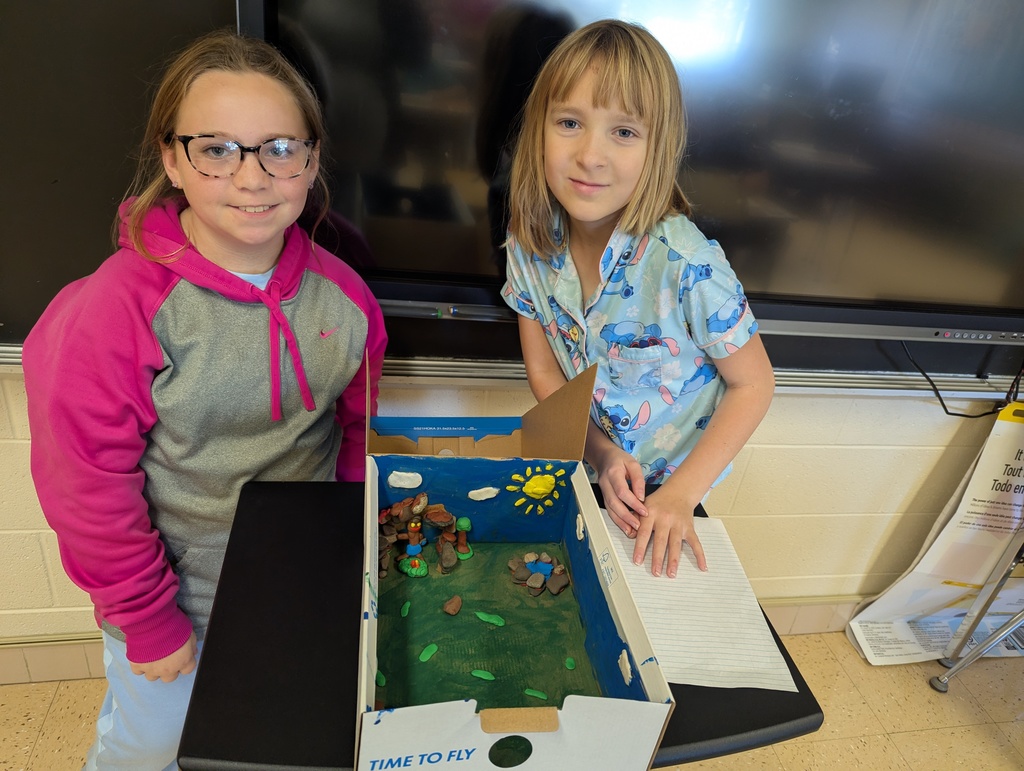 students show off their diorama