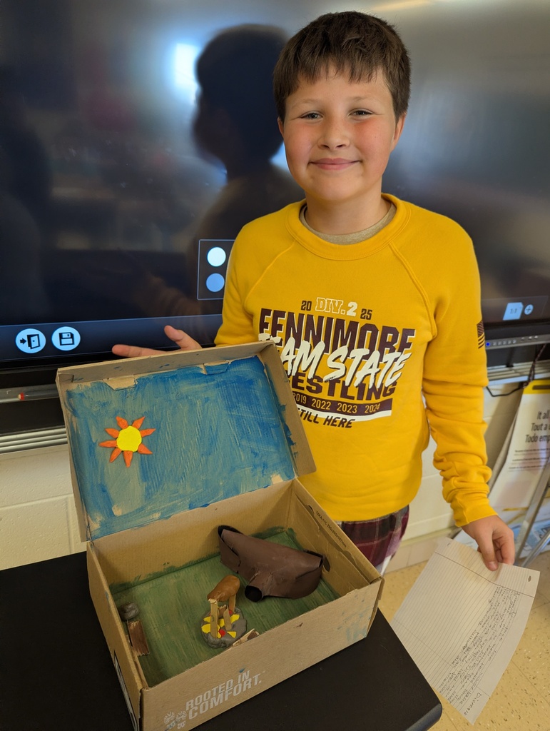 students show off their diorama