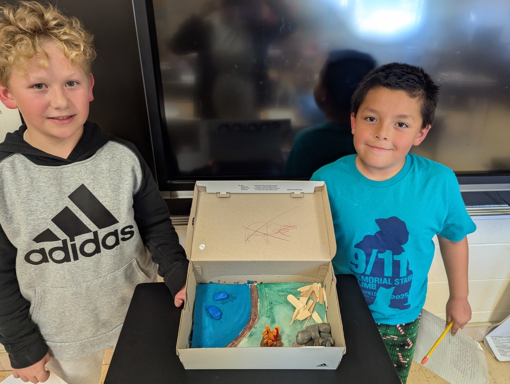 students show off their diorama