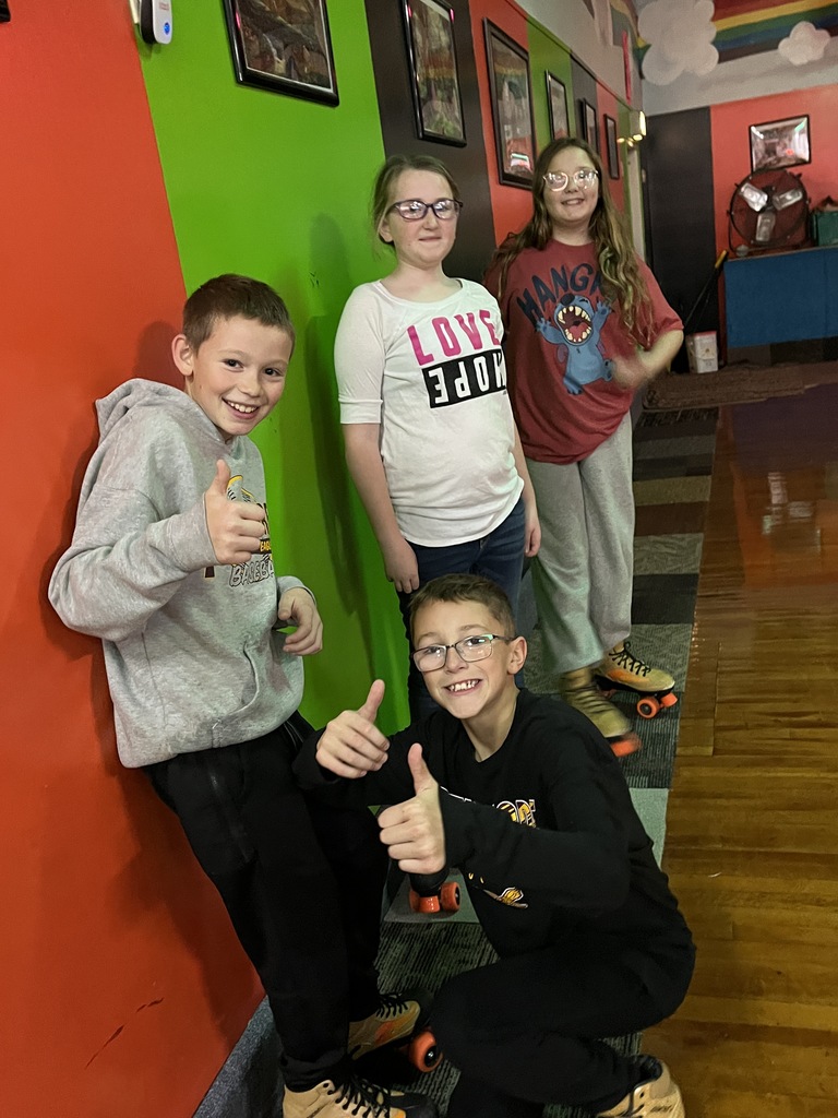 students give the thumbs up while roller skating