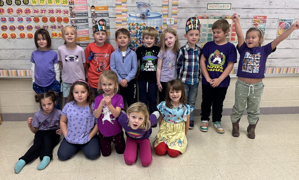 kindergarten grade students dressed in class color -purple