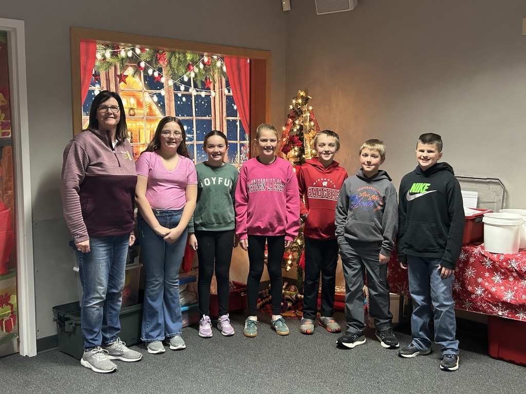 a group of 5th graders and their teacher Mrs. Langmeier pose for a picture at the leadership conference