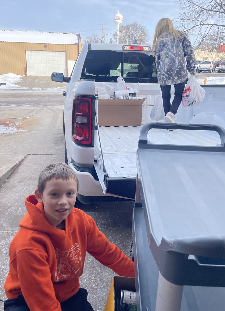 student council members load the truck with the food collected