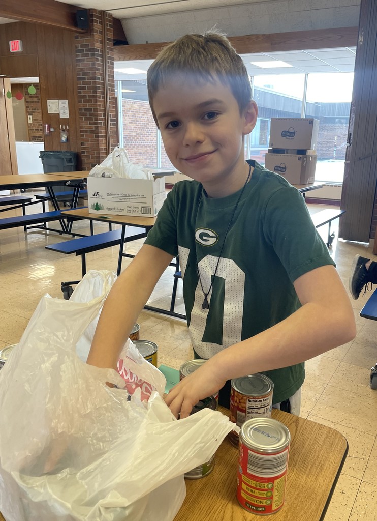 a student council member packs the food into bags
