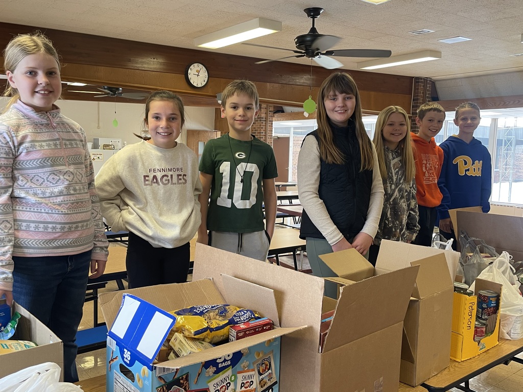FES student council pose for a picture with some of the food collected in the drive