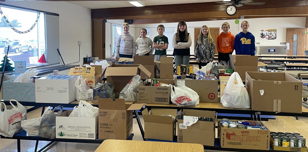 FES student council pose for a picture with some of the food collected in the drive
